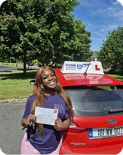 Young woman smiling proudly outdoors on a bright day, holding a certificate, excited expression-4